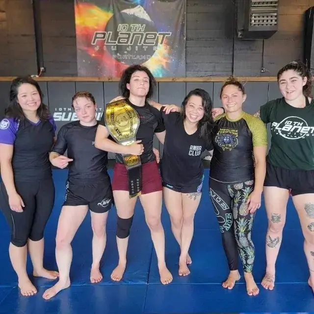Members of the women's class together on the mats after training